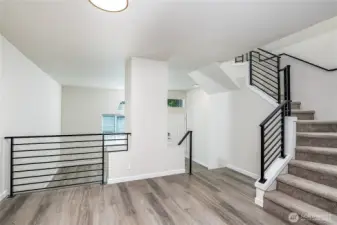 Open and airy layout with modern railings, fresh flooring, and a stylish dining area that connects seamlessly to the living spaces.