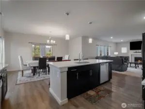 A large kitchen opens directly to the dining table, offering a functional and inviting layout for cooking, dining, and socializing