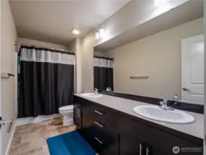 Upstairs bathroom conveniently located near the bedrooms, featuring a full shower/tub and vanity.