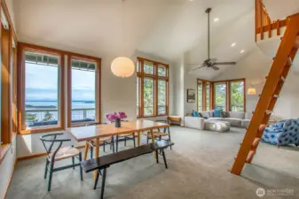 View of dining and living areas from the kitchen.  To the left is door to the deck