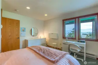 Downstairs bedroom with large windows to enjoy the views.