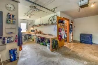 Garage shop area with expansive work bench.  Garage recently had 220 installed for great EV-charging.