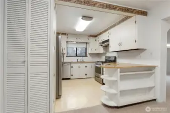 Functional kitchen with ample cabinetry, breakfast bar, and a layout that opens to the main living space.
