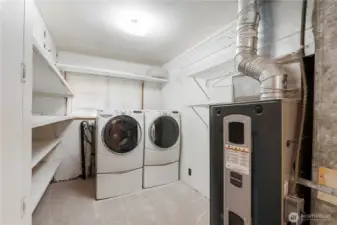 Functional laundry area featuring built-in shelving and convenient storage.