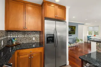 Cherry cabinets frame the stainless-steel appliances.