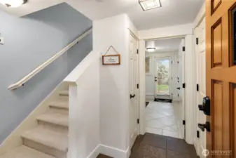 Downstairs, another bedroom is tucked away just off the entry.