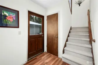 Shared hallway with storage and doors to garage, main home kitchen and deck.