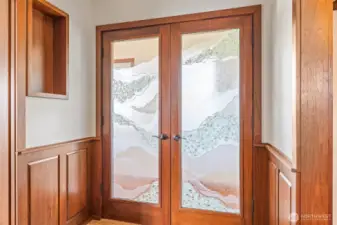 Entrance to primary suite with beautiful etched glass doors.