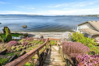 Stairs leading to your sandy beach with terraced gardens.