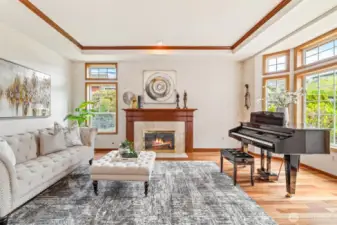 Warm and inviting living room with gas fireplace, wood wrapped windows and beautiful hardwood floors.