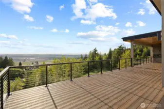 Step out to your big deck, w/covered area including built-in grill & fireplace.