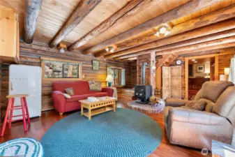 The peeled logs and wood stove add to the charm of the room. And of course, who doesn't need a beverage fridge within easy reach?!