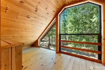 The dormer features a sunroom that overlooks the forest below.