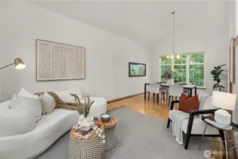 Bright living area adjacent to a formal dining room with vaulted ceilings, creating a warm and elegant atmosphere.