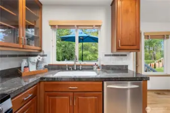 Dishwashing with a view—overlooking the serene back deck and lush surroundings.