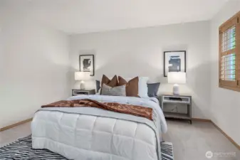 Primary bedroom featuring charming wood shutters that add warmth and timeless style.