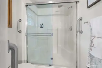 Thoughtfully equipped with grab bars, the shower offers both comfort and accessibility.