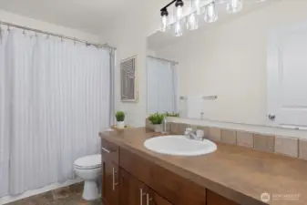 Upstairs guest bathroom featuring modern light fixtures