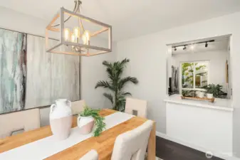Updated lighting above dining room table! Easy pass through window from kitchen.