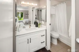 Primary full bathroom with new vanity and quartz countertops.