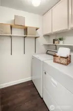 Laundry room with full sized washer & dryer and extra storage.