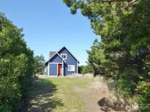 Front of this home situated with a wall of natural vegetation to provide privacy from the street.
