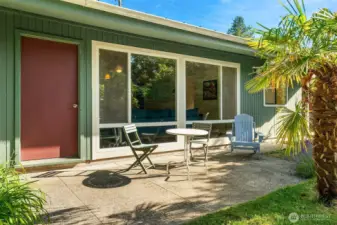 Spacious back patio is nestled in the landscape for a very private feel. Lovely spot for al fresco meals and beverages.