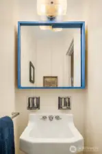 Powder room off the hallway. Vintage sink fixture original to the home. So cute!