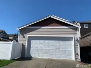 two car garage with two car parking on the drive way.