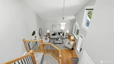 Vaulted ceilings open to entry and living room