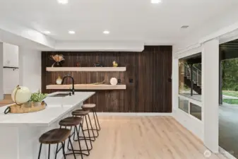 BIG island/wetbar, custom floating shelves and.... a hidden door on the far right....