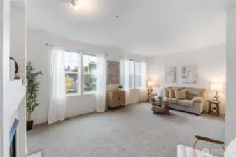 Large living room with cozy fireplace and lots of light