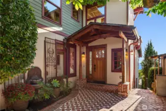 A storybook entry framed by brickwork and wood beams, sets the tone for this timeless Craftsman home, blending charm and elegance with a warm welcome.