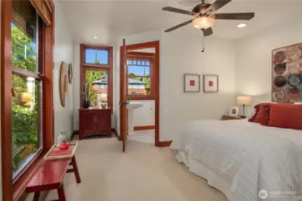This cheerful upper-level bedroom offers warmth and comfort, featuring abundant natural light and a private ensuite for added convenience.