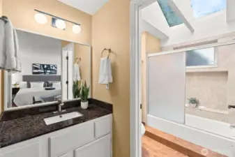 A primary bathroom with the most gorgeous vaulted ceilings and skylights that let in beautiful natural light.