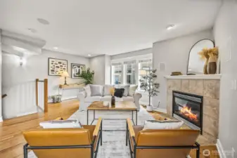 Light-filled living space with generous windows and a cozy, gas fireplace.