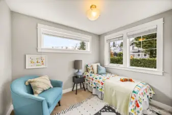 Second bedroom on upper floor following the theme of natural light through the many windows in this home.