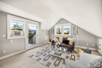 Elevated top-floor retreat filled with natural light and private deck.