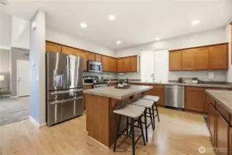 Open kitchen with generous counter space, cabinetry plus a pantry