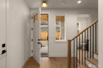 Entry hallway with staircase leading to upstairs bedrooms.
