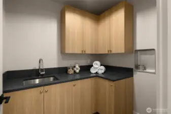 Upstairs laundry room with sink.