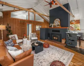 The living room and kitchen and dining areas are light-filled and enjoy vaulted ceilings with exposed collar ties, real wood floors and warm wooden walls. So cozy and relaxing.