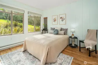 One of two bedrooms off the main living area. Hardwood floors and huge windows. Painted board walls. Very charming.