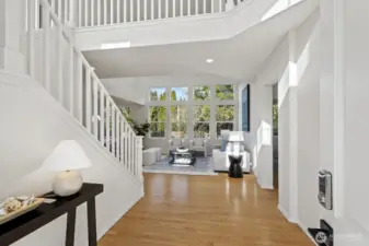 Bright entry with soaring ceilings and natural light that opens to the main living spaces.