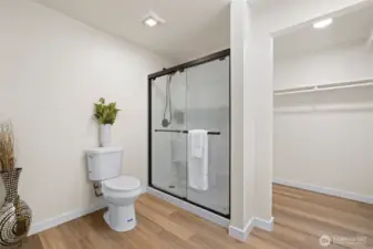 Freshly updated primary bath with a walk-in closet