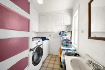 Large laundry room with 1/2 bath off of the kitchen.