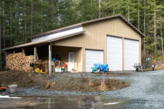 The shop is 40' x 48' and has an additional wood storage covered area. There is 220 power and 12' x 12' doors and 23' ceilings. Inside, there are 7 banks of dual double 8' fluorescence lights and lots of storage.