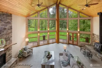 The living or great room is amazing with a wood-lined steel prow that has floor-to-ceiling windows looking out to Ten Mile Creek and the three ponds.