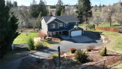 The house has an expansive paved driveway with plenty of room for RV parking and all the toys. The house sits on a large plot of land that allows for the potential of an additional workshop or outbuildings on either side of the house.
