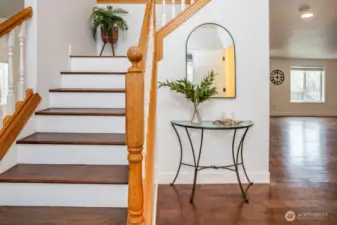 Step through the front door and you’ll find yourself in a dedicated entryway, with soaring ceilings and a stylish staircase. Welcome your guests with tons of natural light, rich wood flooring, freshly painted walls, and new flooring trim.